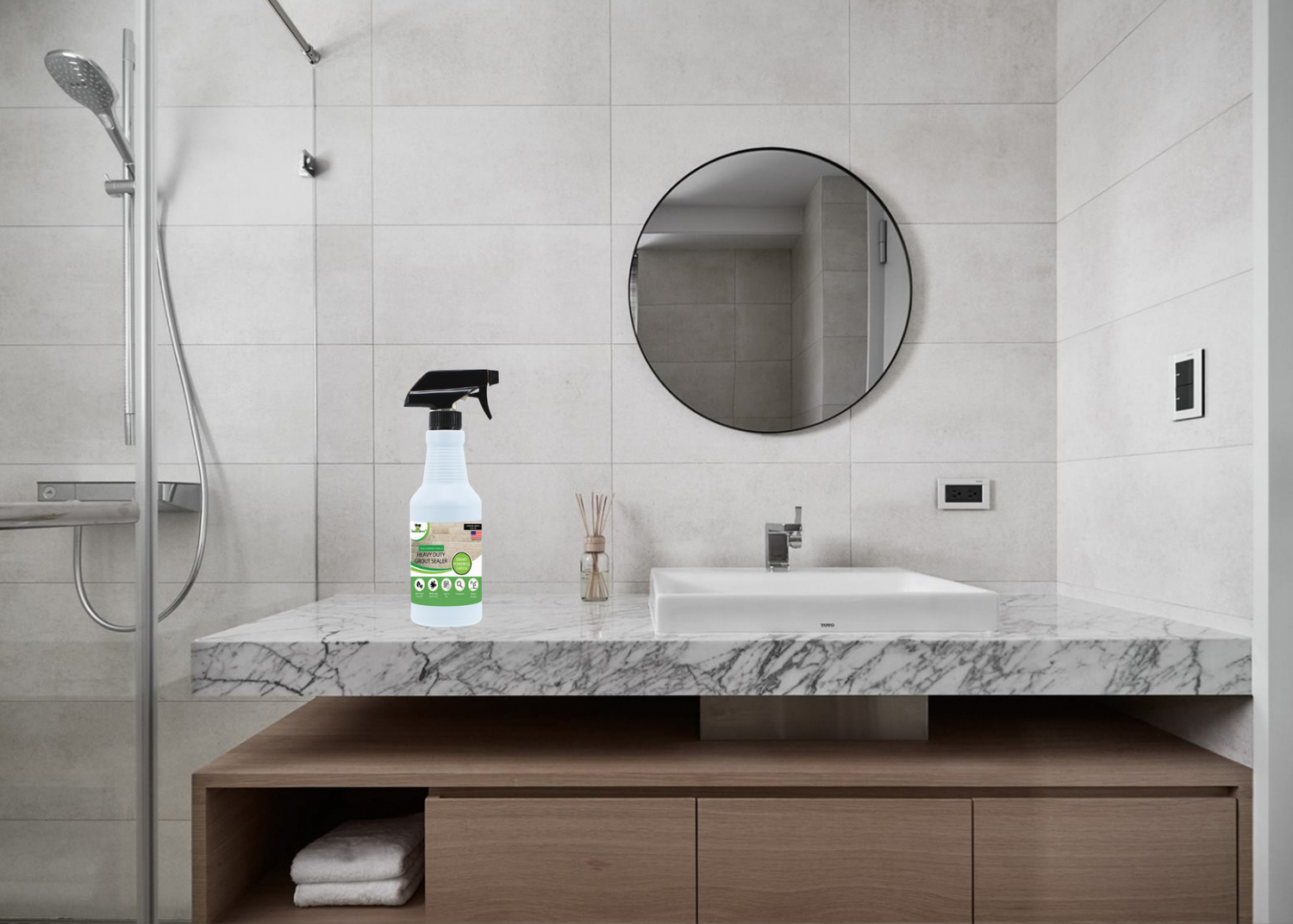 A modern bathroom with a minimalist design features a marble countertop, round mirror, and a spray cleaner prominently displayed.