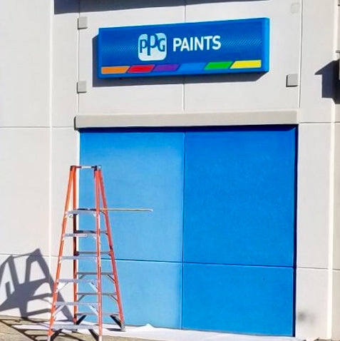 A PPG Paints storefront with a blue exterior and a ladder in front, ready for painting updates.