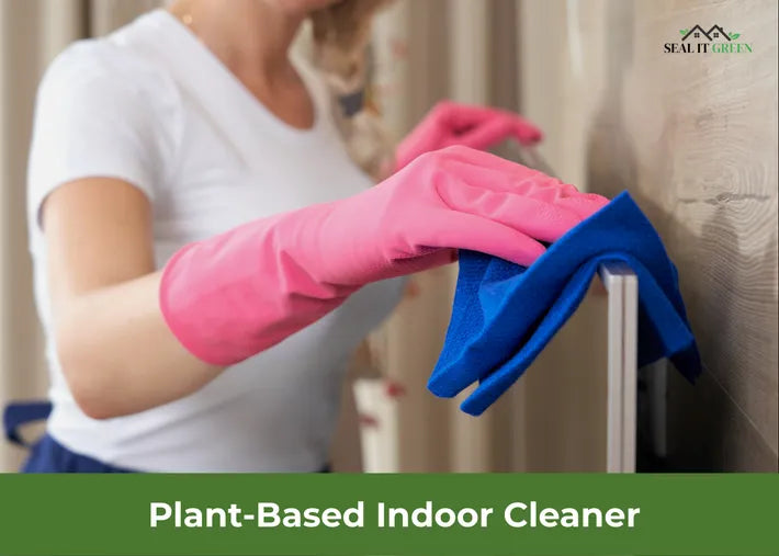 A woman in pink gloves cleans a wall with a blue cloth, promoting plant-based indoor cleaning.