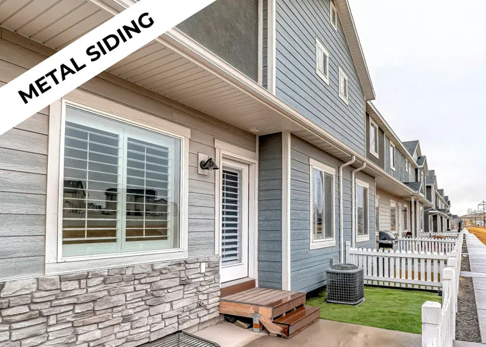 Exterior view of a modern house featuring metal siding, stone accents, and a welcoming front porch.